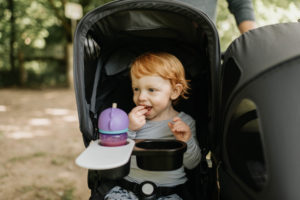 Toddler eating in baby carriage Toddler eating in baby carriage